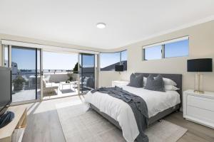 a bedroom with a bed and a large window at Panoramic Water View Apartment in Sylvania