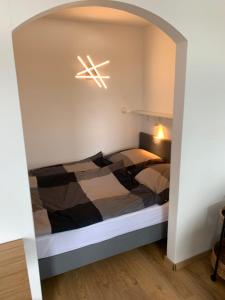 a bedroom with a bed with a light above it at DeichApartments70-78 in Bremerhaven