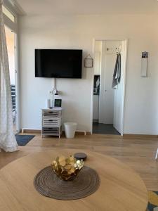 a living room with a bowl of fruit on a table at DeichApartments70-78 in Bremerhaven