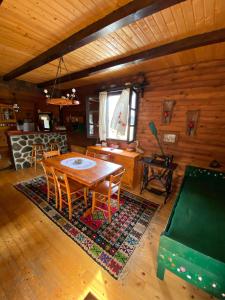 a dining room with a table and chairs in a cabin at Vila Tornik in Zlatibor