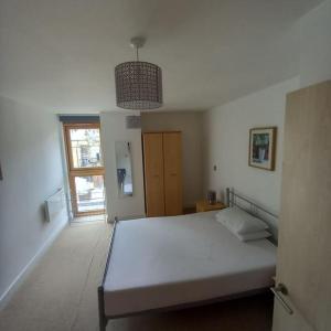a bedroom with a white bed and a window at Centrally situated 1 bedroom apartment! in Birmingham