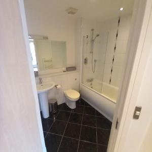 a bathroom with a toilet and a sink and a shower at Centrally situated 1 bedroom apartment! in Birmingham
