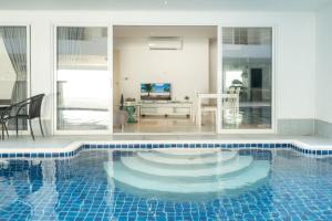 a large swimming pool with a blue tile floor at sunset plaza condominium by Ryan, 600 meters to Karon Beach in Karon Beach