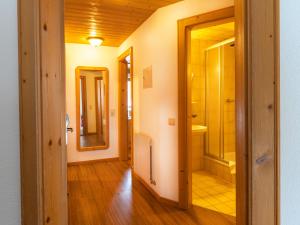 a hallway with a bathroom with a shower and a mirror at Apart Furcletta in Ischgl +64 photos
