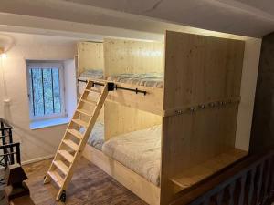 a room with two bunk beds and a window at Votre gite dans l'ancienne Huilerie de Tourtel in Vernosc-lès-Annonay