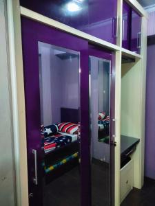 a room with a bunk bed in a purple room at Lily's Room in Cibubur