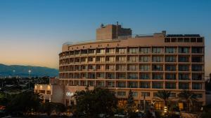 a large building with a tower on top of it at Oryx Hotel Aqaba in Aqaba