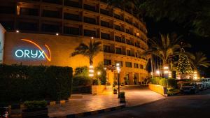 a hotel with a sign on the side of a building at Oryx Hotel Aqaba in Aqaba