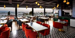 a restaurant with tables and chairs and a view of the ocean at Costera Hotel in Istanbul