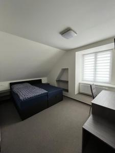 Posteľ alebo postele v izbe v ubytovaní Penzion Sýpka