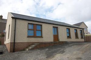 a house with a lot of windows on it at Wesdale, Stromness - 3 Bedroom Holiday Cottage in Orkney