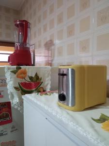 a yellow toaster sitting on top of a counter at Casinha in Socorro