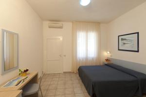 Postel nebo postele na pokoji v ubytování Hotel Le Palme