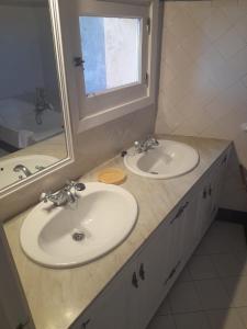 a bathroom with two sinks and a mirror at Navila Giuseppe in Ibiza Town