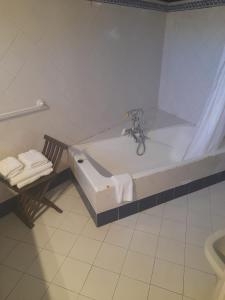 a bathroom with a bath tub and a sink at Navila Giuseppe in Ibiza Town