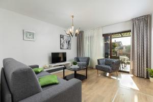 a living room with a couch and two chairs and a television at Apartment VIVIANA in Pula