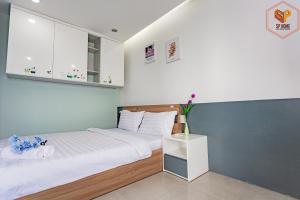 um quarto com uma cama grande e lençóis brancos em Sunrise City - 1 Bed Room - Full Furniture - City View em Ho Chi Minh