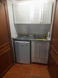 a small kitchen with a sink and a dishwasher at Navila Numero 1 in Ibiza Town