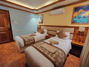 Letto o letti in una camera di Sherpa Home Hotel