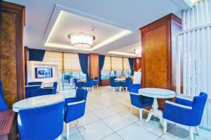 a dining room with blue chairs and tables at Grand Eyuboglu Hotel in Istanbul