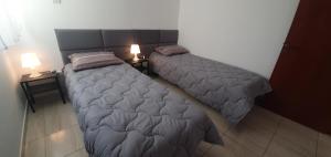 two twin beds in a room with two lamps at Vasilas Holiday Apartment #2 in Larnaka +38 photos