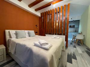 a bedroom with a large bed with towels on it at REDCO FOUR SEASONS IN NEW GUDAURI 302 in Gudauri