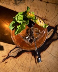 a drink sitting on a wooden table with a spoon at Hotel Faro, a Lopesan Collection Hotel - Adults Only in Maspalomas