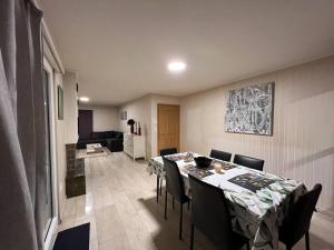 ein Esszimmer mit einem Tisch und Stühlen sowie ein Wohnzimmer in der Unterkunft Specious 5.5 rooms garden house @ Wallisellen in Wallisellen
