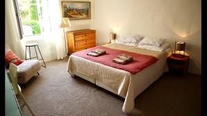 a bedroom with a bed with two bags on it at La Vicomtesse de Seillans in Seillans
