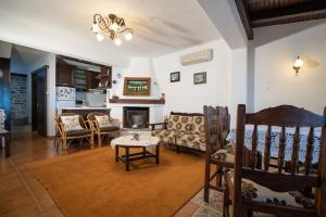 a living room with a couch and a table at Kalimera Villa, Afissos Pelion in Afissos