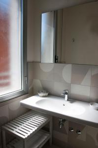 a bathroom with a white sink and a mirror at Hotel Ondina e Milazzo in Cervia