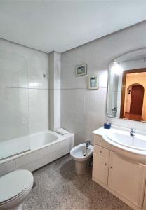 a bathroom with a toilet and a sink and a tub at Casa Suni Alicante Centro in Alicante +47 photos