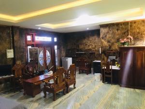 a room with chairs and a table and a desk at xaythone guest house in Savannakhet