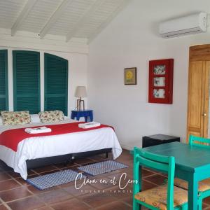 a bedroom with a bed and a blue table at Clara en el Cerro in Tandil
