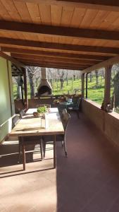 a patio with a table and an outdoor oven at Chalet immerso nel Bosco in Melfi +15 photos