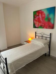 un letto in una stanza con un dipinto sul muro di Delizioso Appartamento a Ceglie Messapica