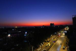 a view of a city street at night with a sunset at Staybook Hotel Aira, Paharganj, New Delhi Railway Station in New Delhi