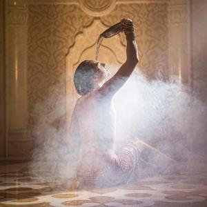 a woman is sitting in a room with a hairdryer at Cocoon inn&Spa in Saint-Saturnin-les-Avignon