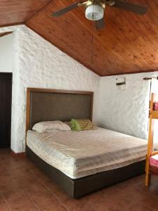 a bed in a bedroom with a wooden ceiling at Villa Valentina in La Tebaida