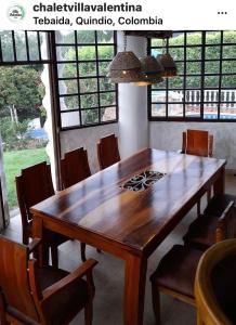 a wooden table and chairs in a room at Villa Valentina in La Tebaida