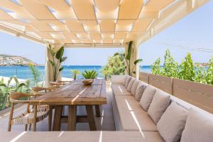 Un patio al aire libre con una mesa y sillas de madera. en Villa Moana, en Balíon