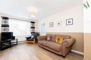 ein Wohnzimmer mit einem Sofa und einem TV in der Unterkunft Wroxton Close TSAC in Middlesbrough