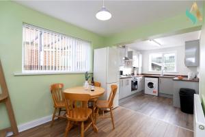 a kitchen and dining room with a table and chairs at Wroxton Close TSAC in Middlesbrough