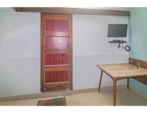 a room with a desk and a book shelf at Hotel Dharamlok,Agra in Agra