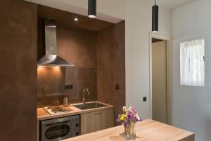 a kitchen with a sink and a counter with flowers at Pelagia Sea Side in Acharavi