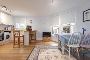 a kitchen and living room with a table and chairs at Marine Park - Perfect Elie Base - 1 min to Beach in Elie