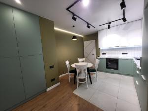 a kitchen with a table and chairs in a room at PRESTIGE-CENTER in Rivne