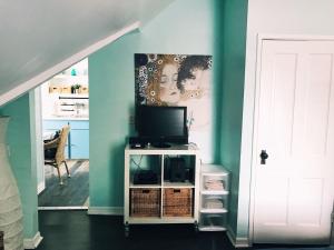 a living room with a tv on a white cabinet at Barra Villa Resort House I in Fort Myers