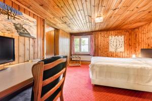 a bedroom with a bed and a tv in a room at Berghaus Tschengla by A-Appartments in Bürserberg