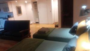 1 dormitorio con 2 camas y 1 silla en una habitación en Bambú Soho en Buenos Aires